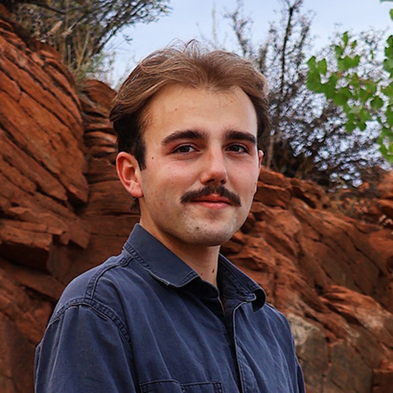 Patrick McCabe in a navy shirt in front of red rock
